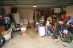 Messy, cluttered home garage in need of self storage services